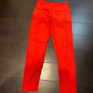 Red Zyia leggings with vented bottom detail